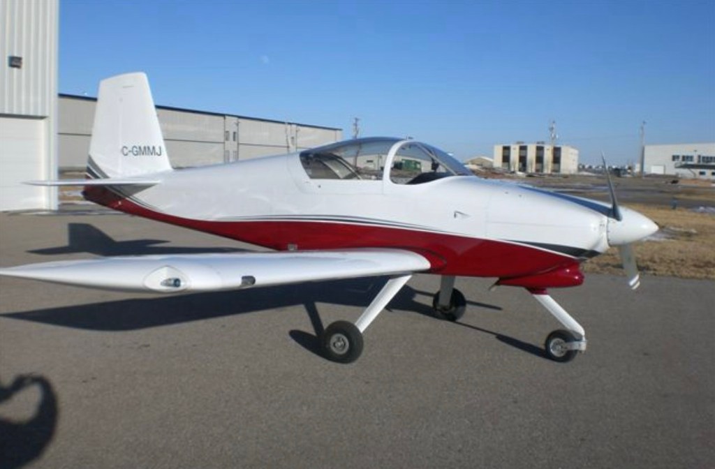 Photo: Parked red & white airplane ©CRFCYYC