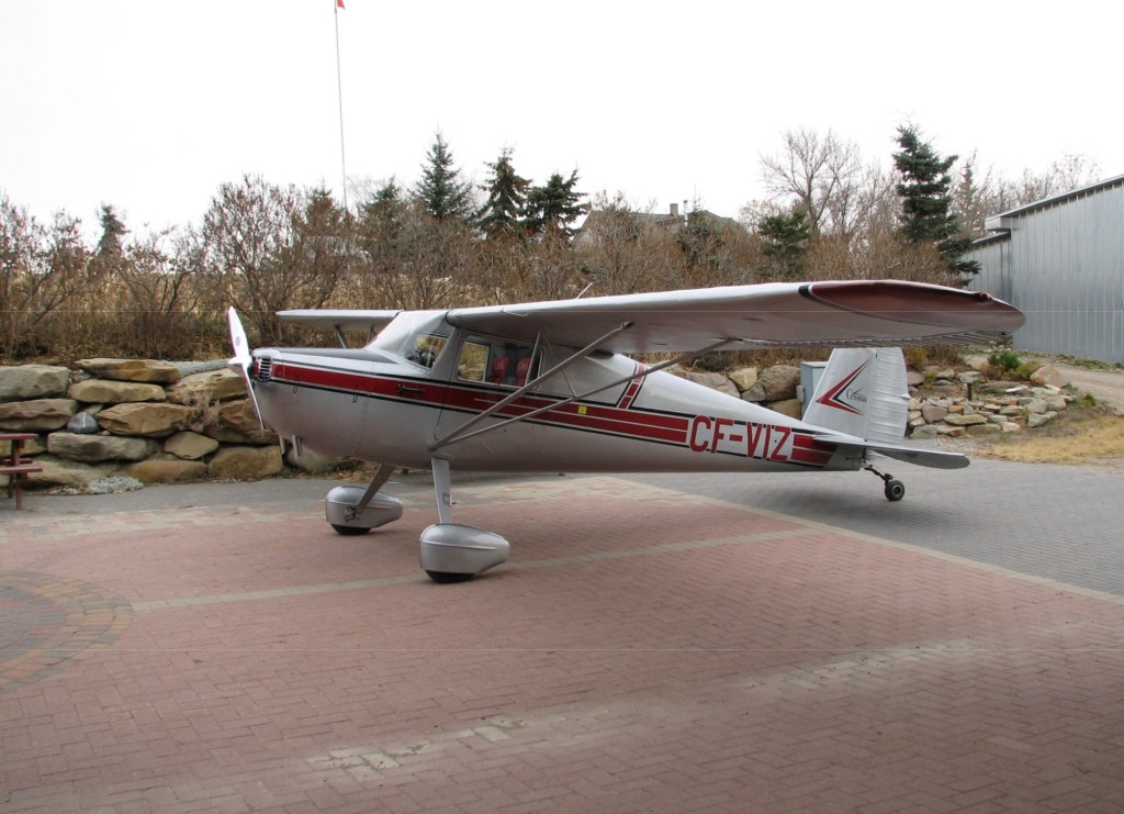 Photo: Red & white parked airplane ©CRFCYYC