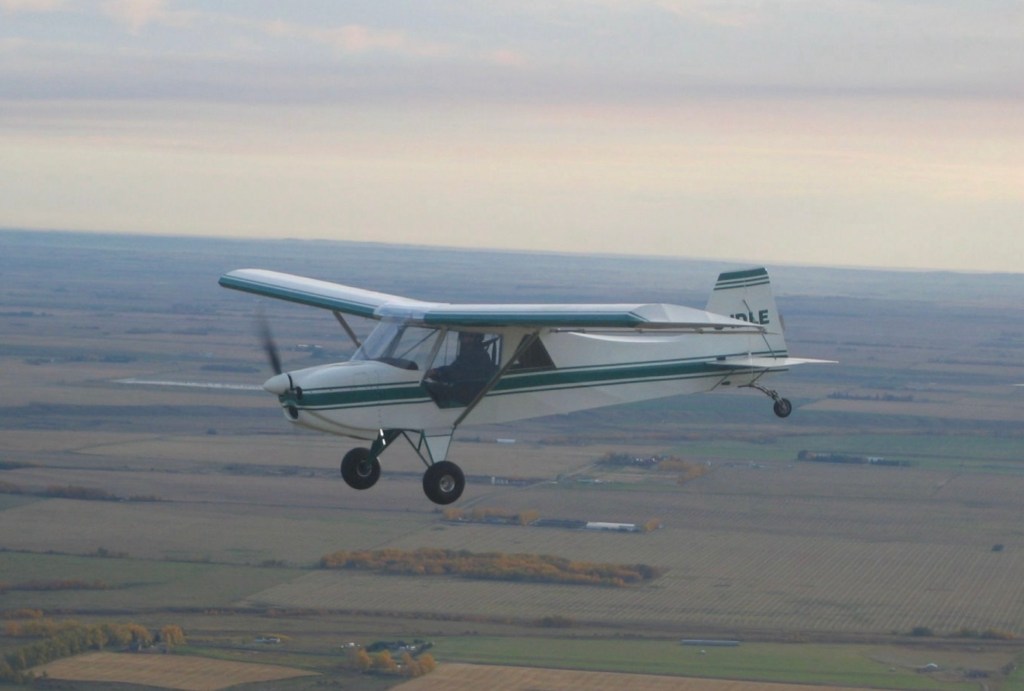 Photo: Green & white airplane flying ©CRFCYYC