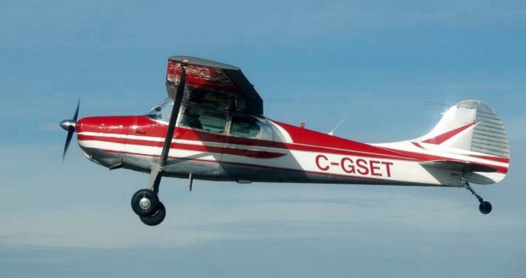 Photo: Red & white airplane flying ©CRFCYYC